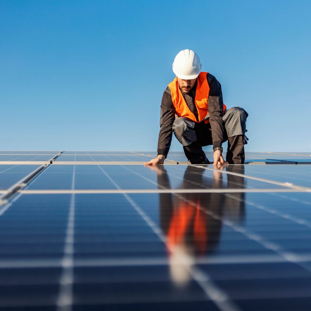 Technician installing solar panels